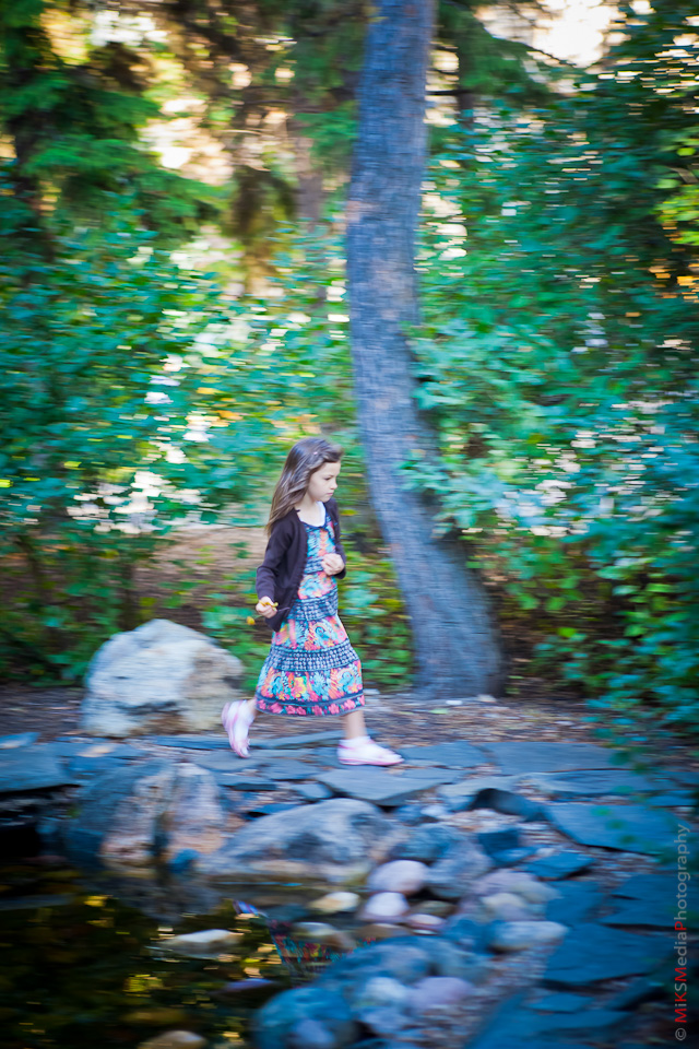 young girl running in edmonton park trail